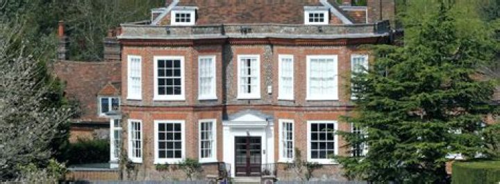 How can I find out if a building is listed in England?